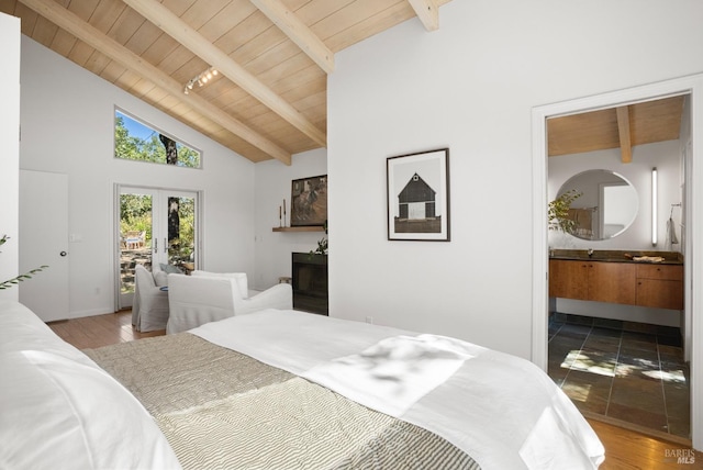 bedroom with french doors, wooden ceiling, wood finished floors, and beam ceiling