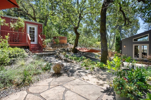 view of yard featuring french doors and a hot tub