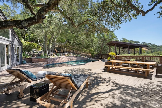 exterior space featuring a wooden deck and a fenced in pool