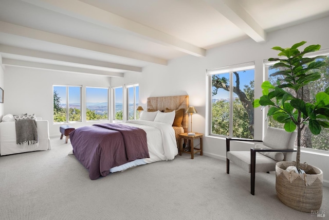 bedroom featuring baseboards, beamed ceiling, and light colored carpet