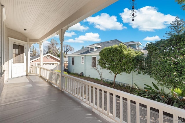 view of front of home featuring covered porch, a front yard, and roof with shingles