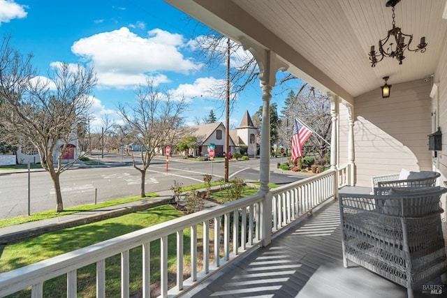 wooden deck with covered porch and a residential view