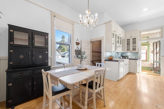 dining space featuring a notable chandelier and light wood-style floors