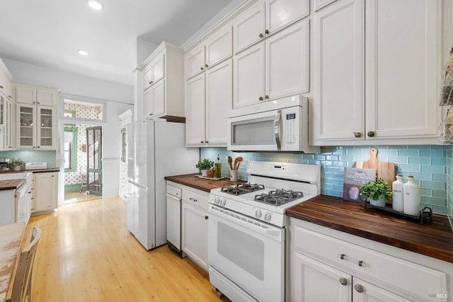 kitchen with white cabinetry, white appliances, light wood-style flooring, and wooden counters