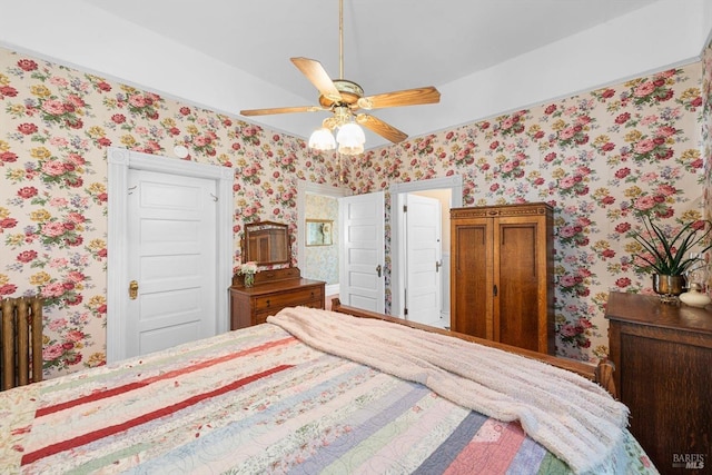 bedroom featuring ceiling fan and wallpapered walls