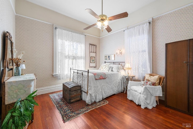 bedroom featuring wallpapered walls, hardwood / wood-style flooring, baseboards, and ceiling fan