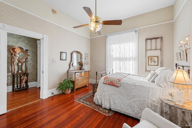 bedroom featuring baseboards, wood finished floors, a ceiling fan, and wallpapered walls