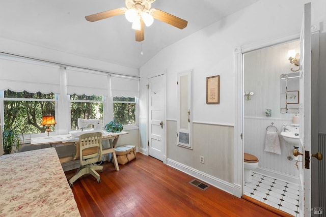 dining space with visible vents, wood finished floors, a ceiling fan, and vaulted ceiling