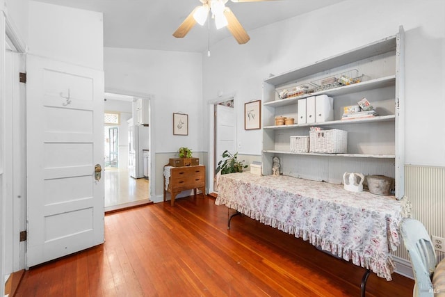 bedroom featuring hardwood / wood-style flooring, lofted ceiling, and ceiling fan