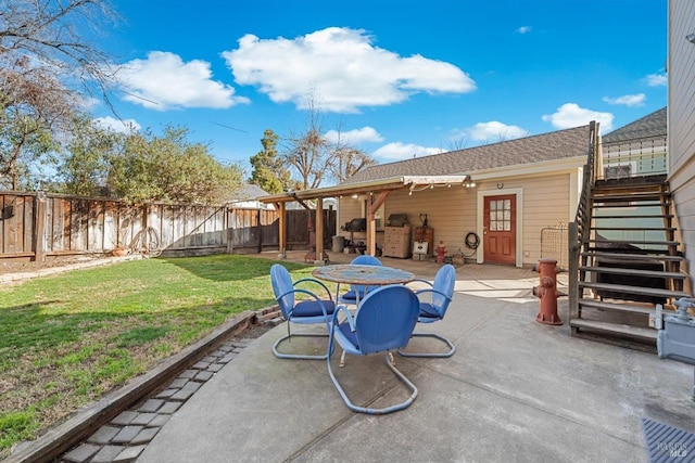 view of patio / terrace with outdoor dining area, stairs, and a fenced backyard