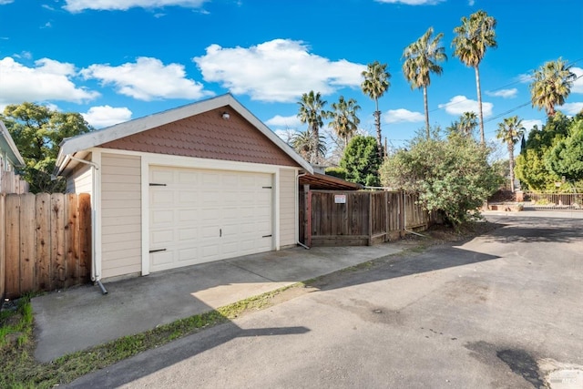 detached garage featuring fence