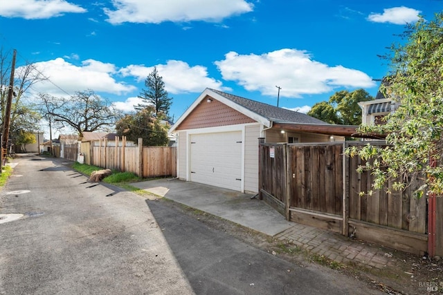 detached garage featuring fence