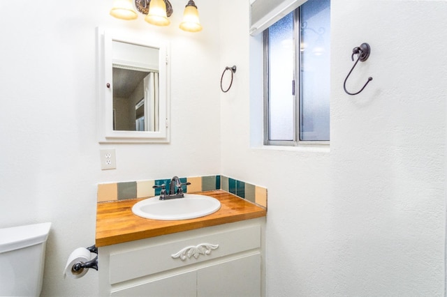 bathroom with vanity and toilet