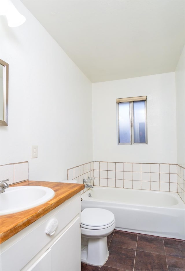 bathroom featuring a bath, toilet, and vanity