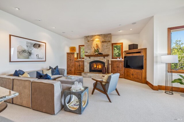 living room featuring light carpet, recessed lighting, a fireplace, and baseboards