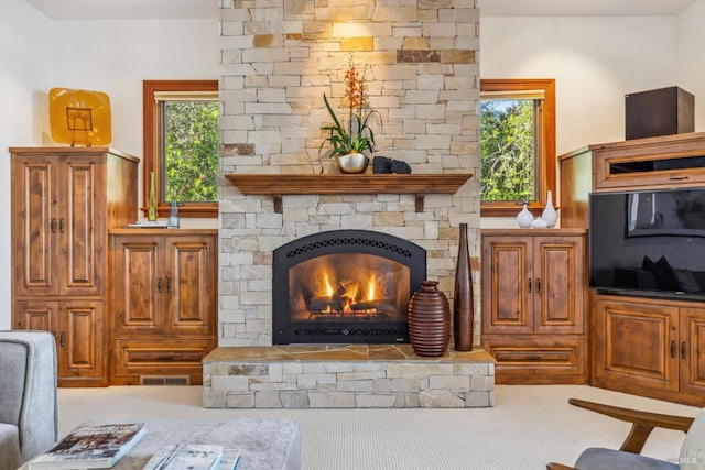 interior space featuring visible vents and a stone fireplace