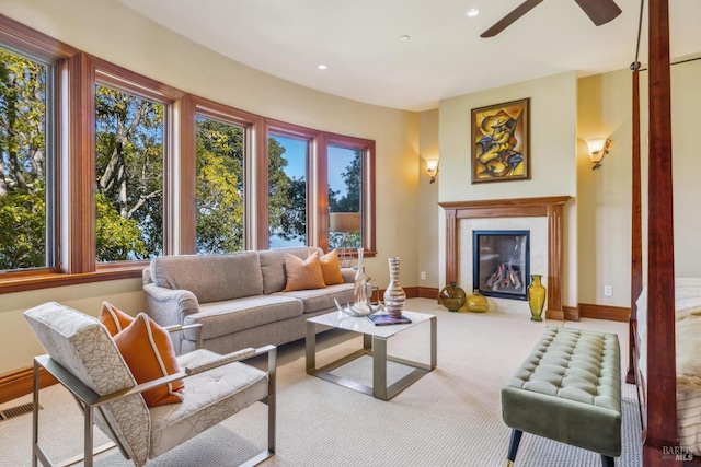 sunroom featuring a fireplace, visible vents, and a ceiling fan