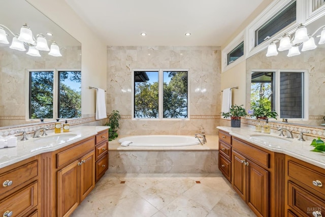 bathroom with two vanities, a sink, a bath, and tile walls