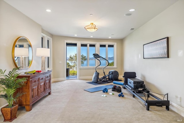 workout room with baseboards, recessed lighting, and light colored carpet