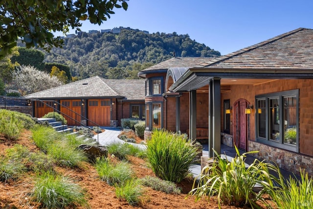 back of property featuring stone siding