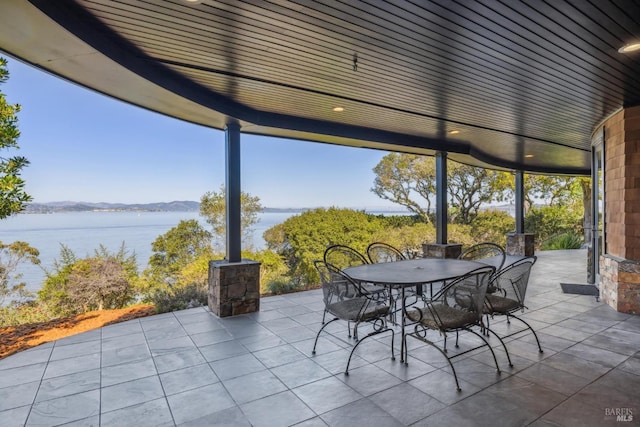 view of patio / terrace with outdoor dining space and a water view