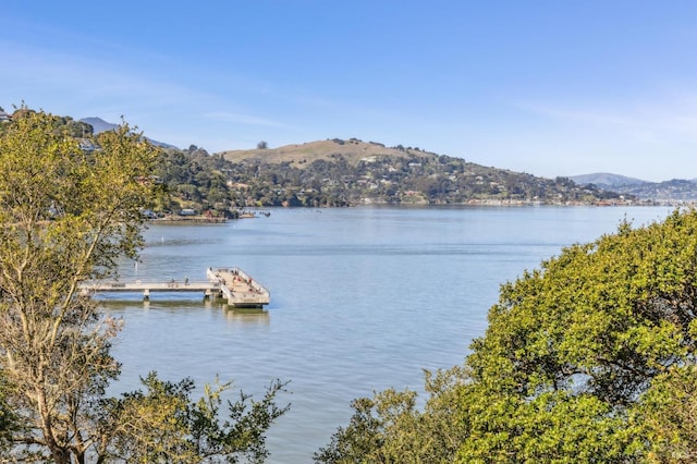 property view of water featuring a floating dock and a mountain view