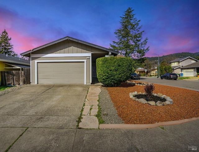 ranch-style house featuring an attached garage and concrete driveway