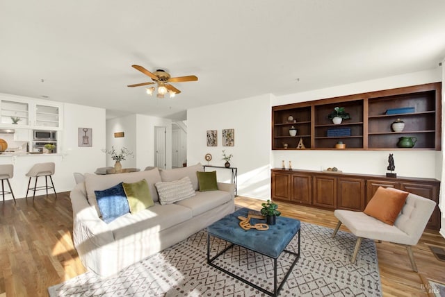 living area featuring ceiling fan and light wood-style flooring