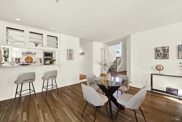 dining space featuring stairs, baseboards, dark wood finished floors, and recessed lighting