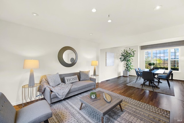 living room with recessed lighting, baseboards, and wood finished floors