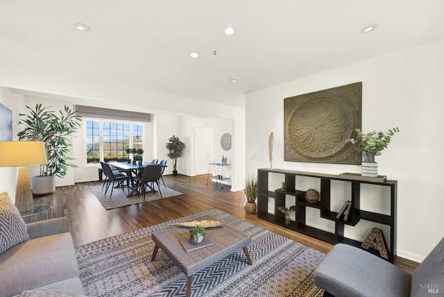 living room with recessed lighting, baseboards, and wood finished floors