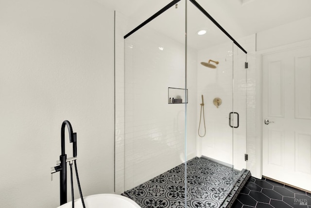 full bathroom featuring a shower stall and tile patterned floors