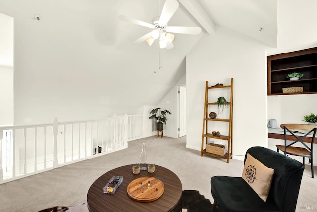 sitting room with lofted ceiling with beams, ceiling fan, and carpet floors