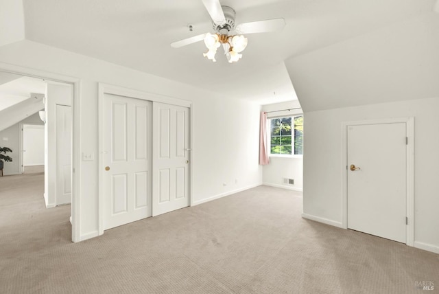 additional living space featuring vaulted ceiling, carpet, visible vents, and baseboards