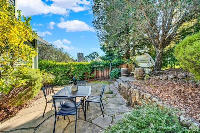 view of patio with outdoor dining area and fence