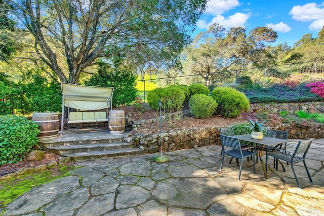 view of patio / terrace featuring fence and outdoor dining space