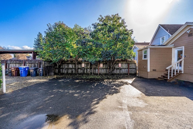 view of yard with entry steps and fence