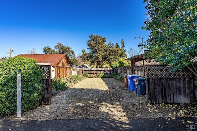 view of yard featuring an outdoor structure and a fenced backyard