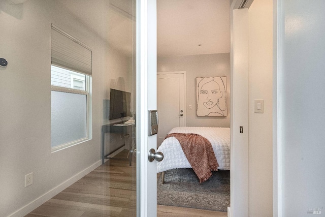 bathroom featuring wood finished floors and baseboards