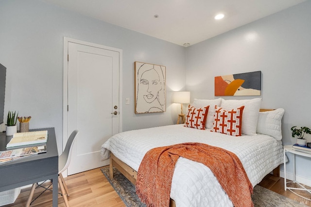 bedroom with wood finished floors and recessed lighting