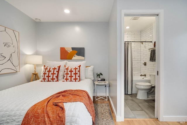 bedroom with connected bathroom, recessed lighting, wood finished floors, visible vents, and baseboards