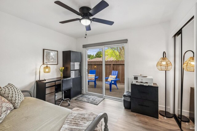 bedroom featuring access to outside and wood finished floors