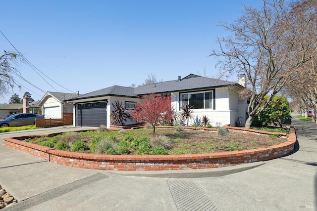 view of front of house with roof with shingles, a garage, driveway, and brick siding