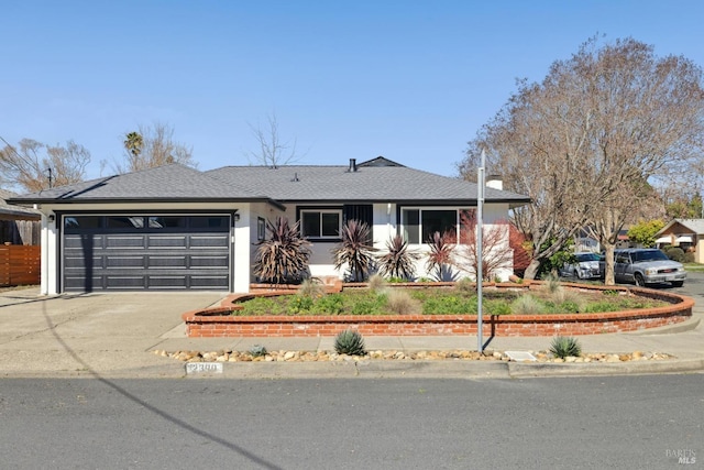 view of front of home featuring roof with shingles, an attached garage, and aphalt driveway