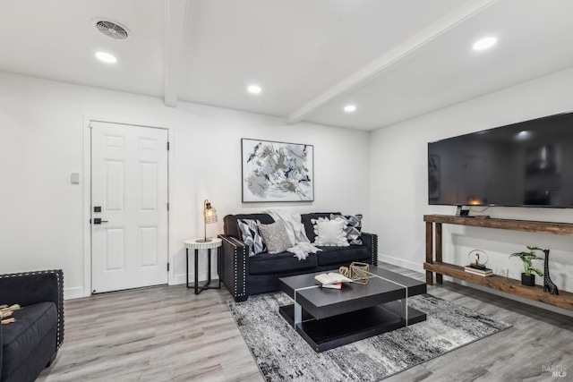 living area with recessed lighting, light wood finished floors, visible vents, and beam ceiling