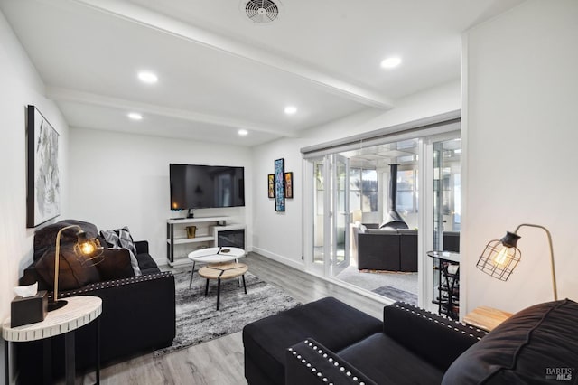 living room with visible vents, recessed lighting, wood finished floors, and beamed ceiling