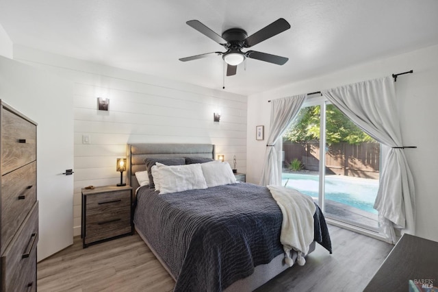 bedroom with light wood-style floors, access to exterior, and a ceiling fan
