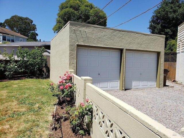 detached garage featuring fence