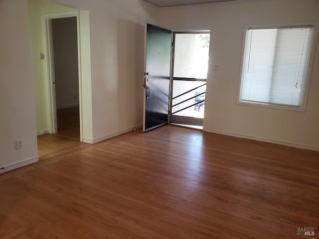 empty room featuring baseboards and wood finished floors