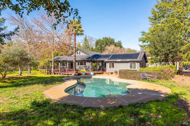 view of pool featuring a deck and a yard